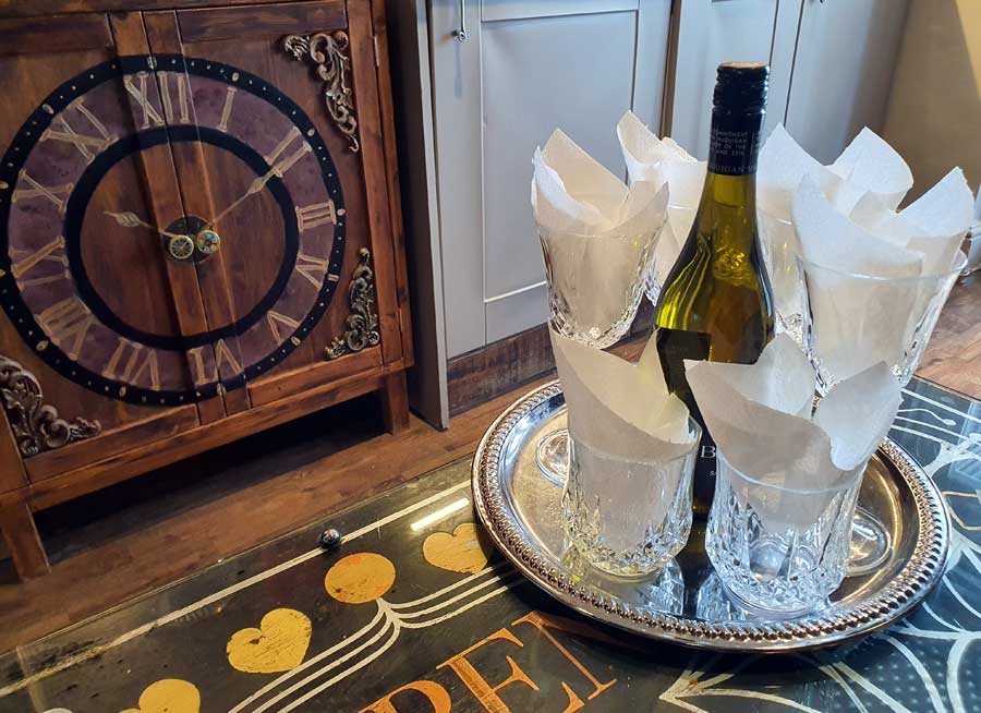 Bottle of wine and 6 glasses at Looking Glass Cottage, Brighton UK