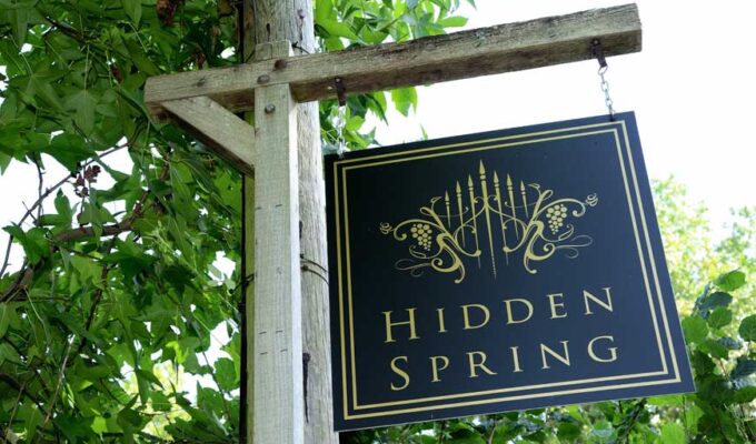 Hanging Hidden Spring Vineyard sign at entrance to vineyard at Vines Cross Road, East Sussex