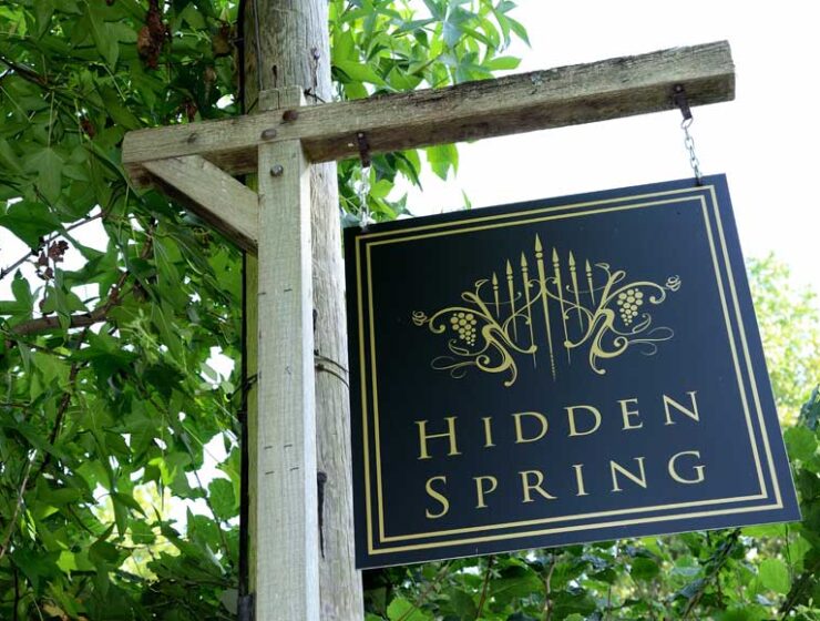 Hanging Hidden Spring Vineyard sign at entrance to vineyard at Vines Cross Road, East Sussex