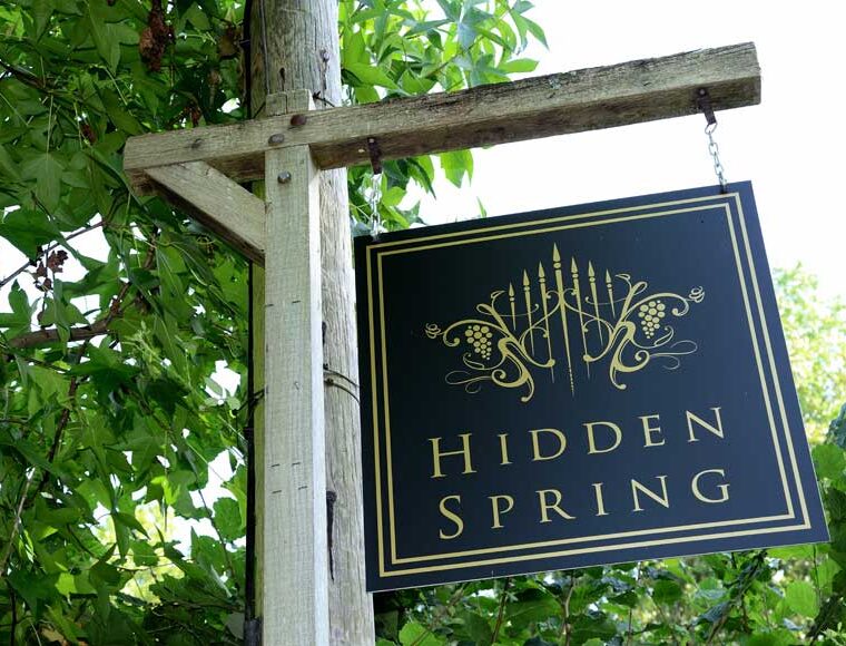 Hanging Hidden Spring Vineyard sign at entrance to vineyard at Vines Cross Road, East Sussex