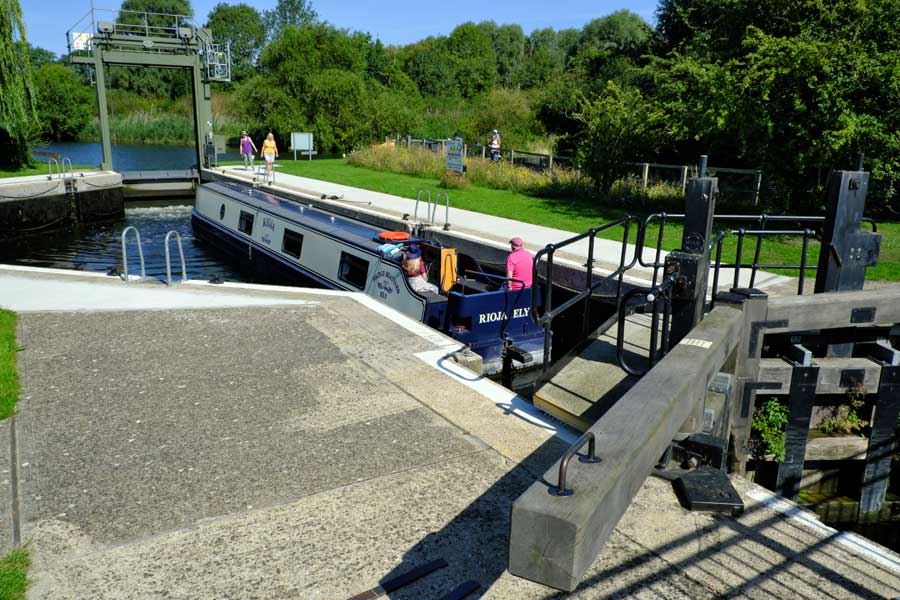 Lock Gates and narrowboat in the August sunshine at Houghton in Cambridgeshire