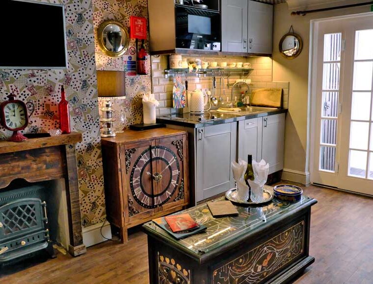 Lounge and kitchenette at Looking Glass Cottage, Brighton, UK