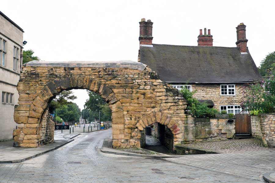 Newport Arch, a preserved remnant of Roman times, a gateway at the northern end of the old city of Lincoln that local traffic still uses.