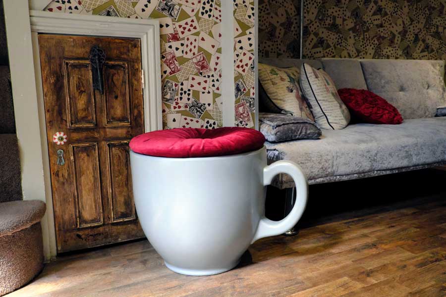 Teacup shaped seat and small door in Looking Glass Cottage Brighton UK