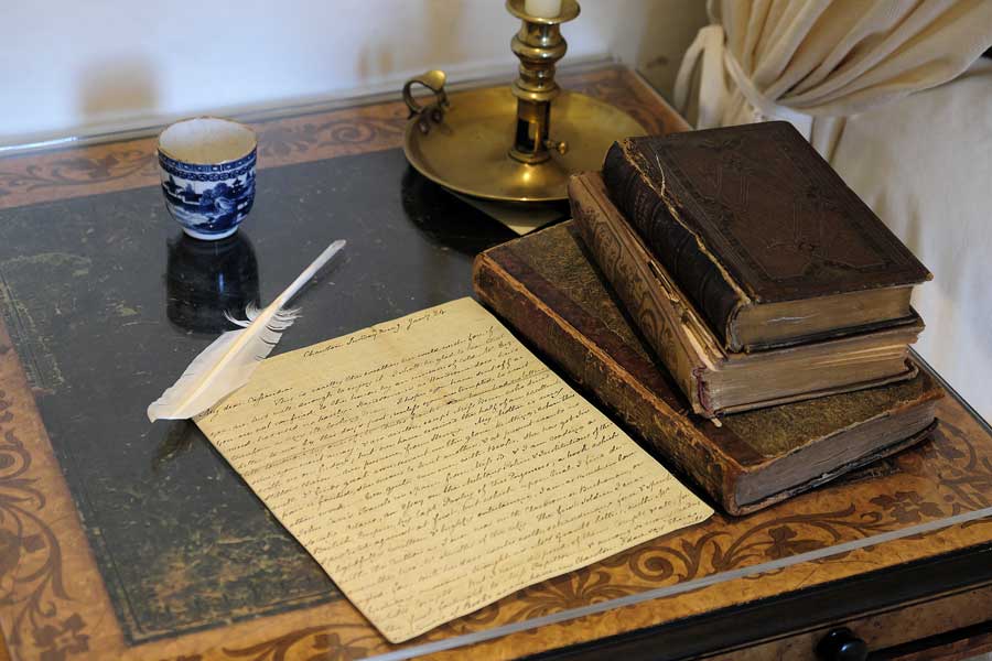 Handwritten letter and books on table Jane Austen House Chawton Hampshire