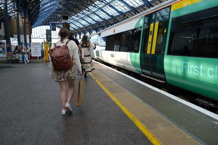 Passengers on platform boarding train at Brighton Railway station