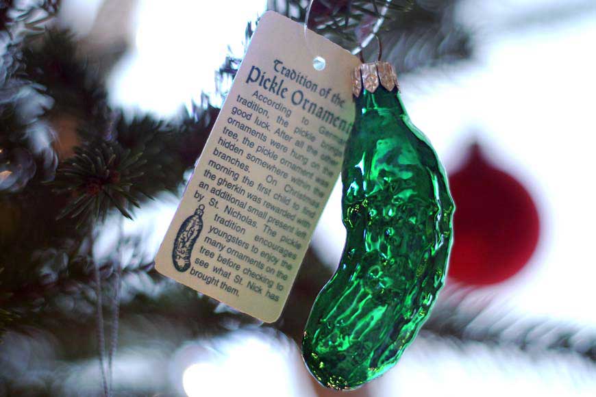 Christmas ornament of a Pickle hanging on a Christmas tree