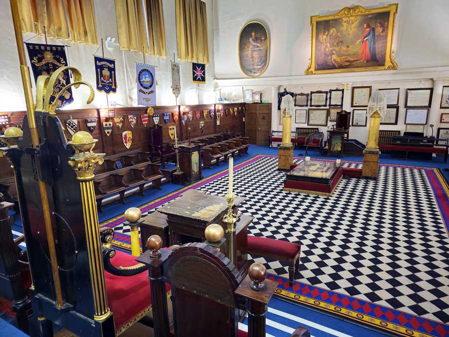 Interior of Masonic main hall in the former Old Theatre Royal Bath UK, showing the chequered floor and seating for a Masonic Meeting