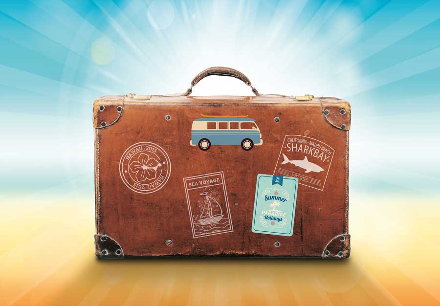Battered brown suitcase with holiday stickers