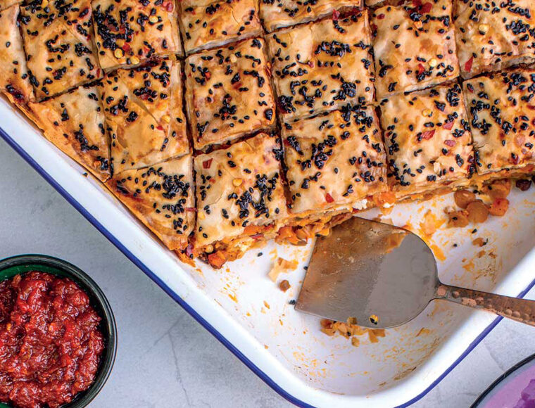 Butternut squash and chickpea Baklava in white serving dish. Recipe from The Garlic Story by Kumud Gandhi
