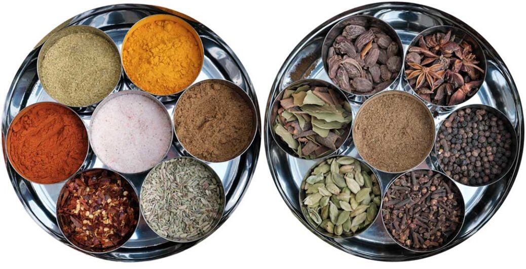 Two spice tins containing various herbs and spices