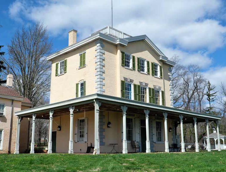 Exterior of Belmont Mansion in Fairmount Park Philadelphia showing dark green shutters and verandah
