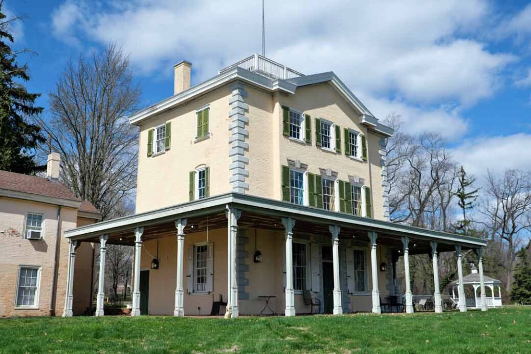 Exterior of Belmont Mansion in Fairmount Park Philadelphia showing dark green shutters and verandah