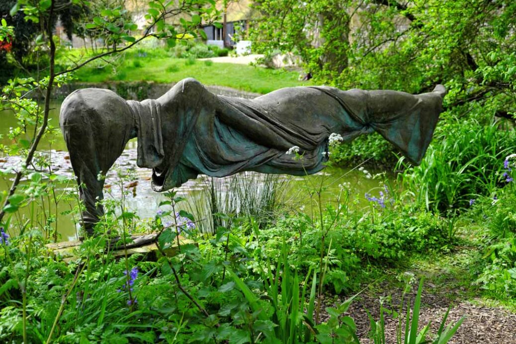 Levitating Lady sculpture by Quentin Bell by the pond in the Charleston Farmhouse garden Firle East Sussex