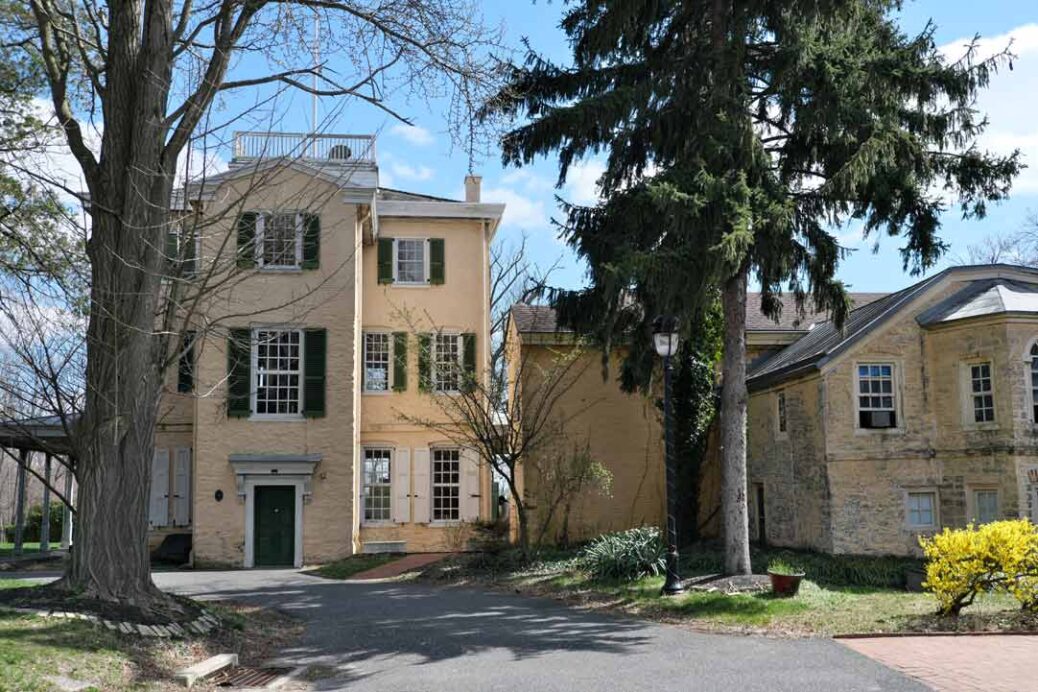 Rear of the restored 18th century Belmont Mansion showing windows with dark green shutters