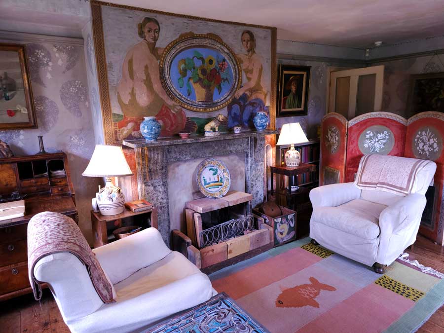 Sitting room with painted nudes and flowers at Charleston Farmhouse East Sussex