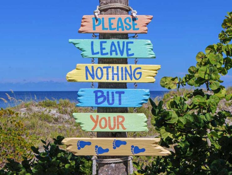 Sign at the beach saying 'Please leave nothing but your footprints'