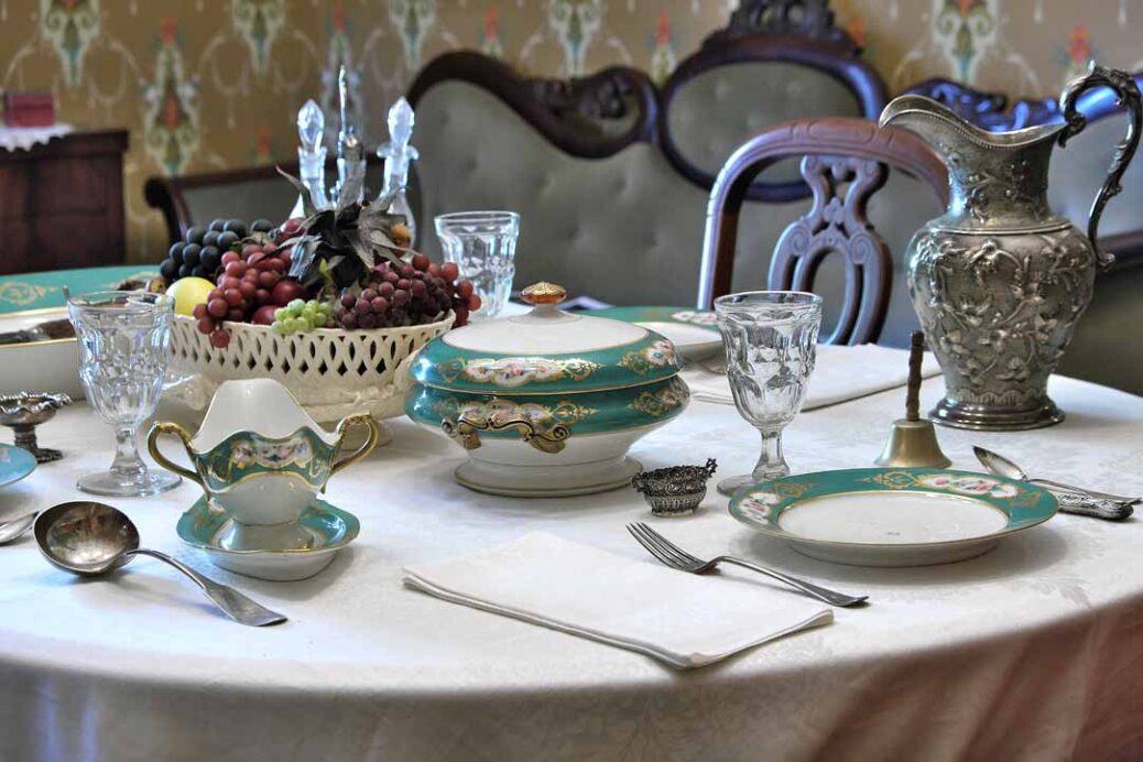 Green and gold dinner service on Victorian era dining table at Ebenezer Maxwell Mansion Philadelphia