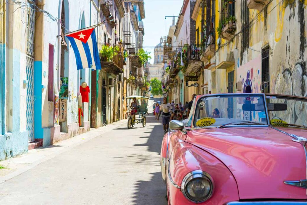 Backstreet in Havana, Cuba with pink car