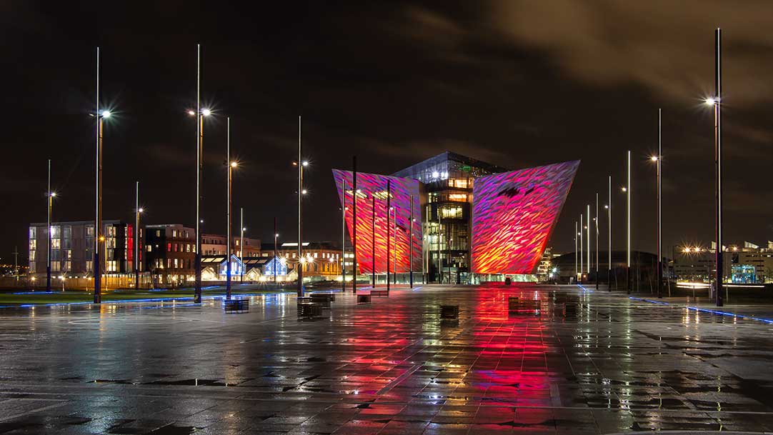Titanic Belfast as viewed on a damp night - taken between showers with the coloured lights reflecting in the puddles.