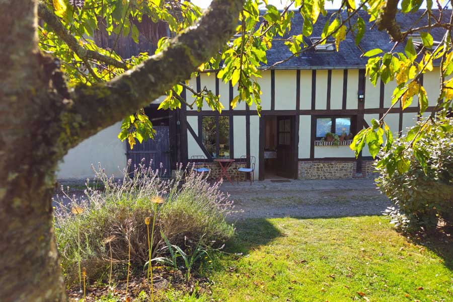 Looking across the lawn to the Gîte La Cave de Gustave in La Ferté en Ouche Normandy France