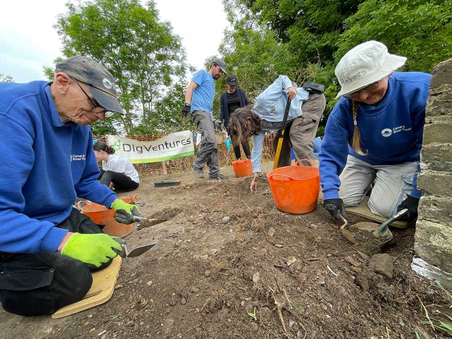 Volunteers using trowels on a dig with DigVentures and Canal and River Trust