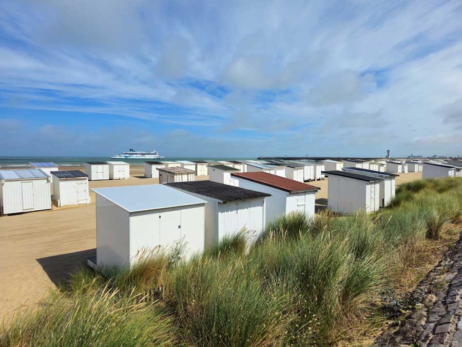 The white painted beach huts on the sand at Calais Plage in Calais France