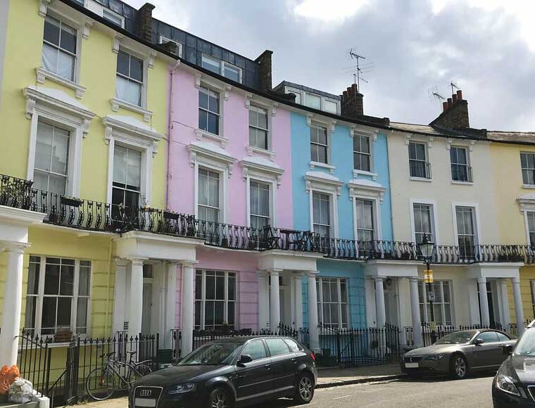 Exterior of pastel-coloured houses in Chalcot Crescent, Primrose Hill in London used to film Paddington Bear