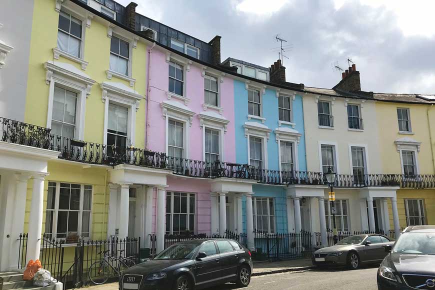Exterior of pastel-coloured houses in Chalcot Crescent, Primrose Hill in London used to film Paddington Bear