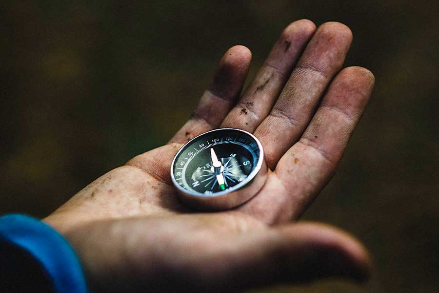 Hand holding a compass