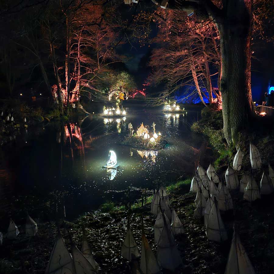 Glowing paper lanterns on the pond. Home of the Tree Tribes at Wakehurst Glow Wild