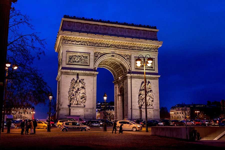 Arc de Triomphe in Paris, France lit up at night