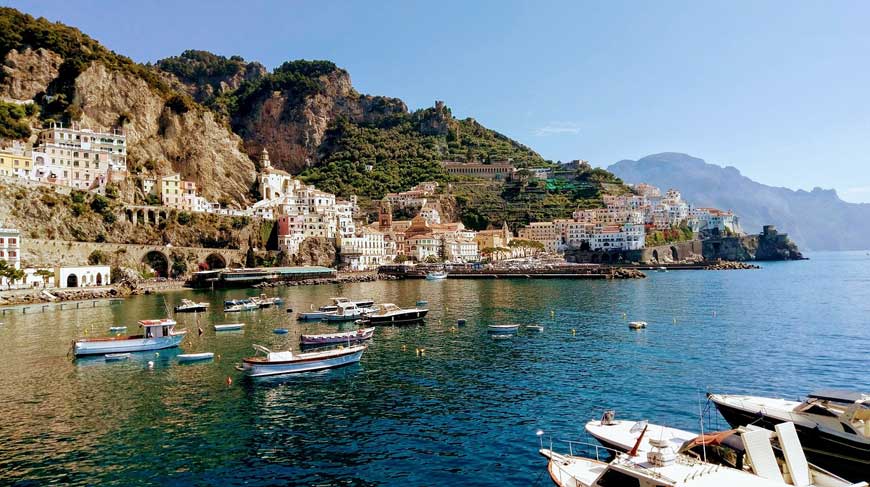 Houses on the hillside and boats in the harbour on the Amalfi Coast, Italy