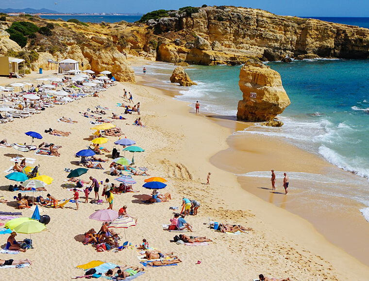 People sunbathing on the beach, Praia de São Rafael, Albufeira, Portugal