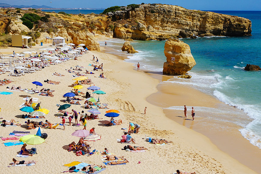 People sunbathing on the beach, Praia de São Rafael, Albufeira, Portugal