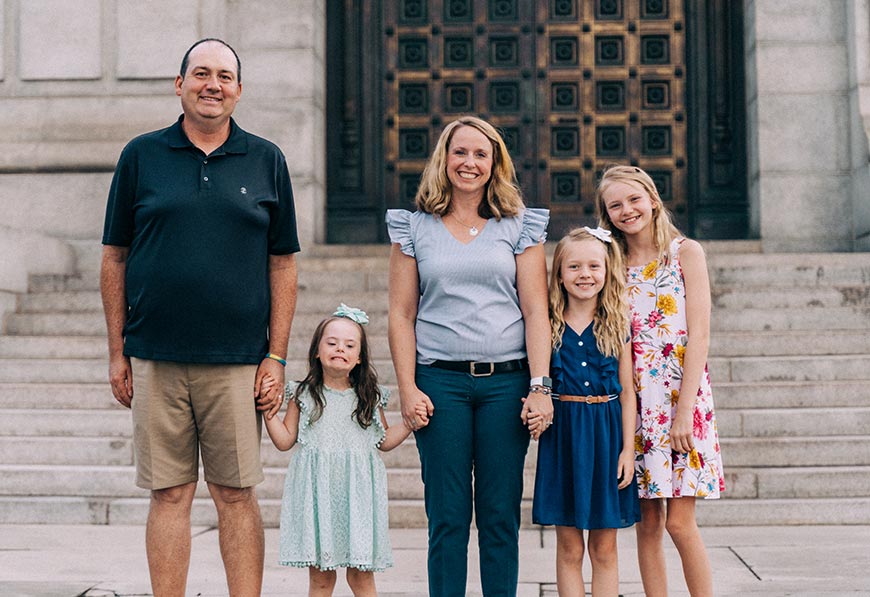 Smiling family standing side by side and holding hands
Photo by Jake Muller on Disability Is Beautiful