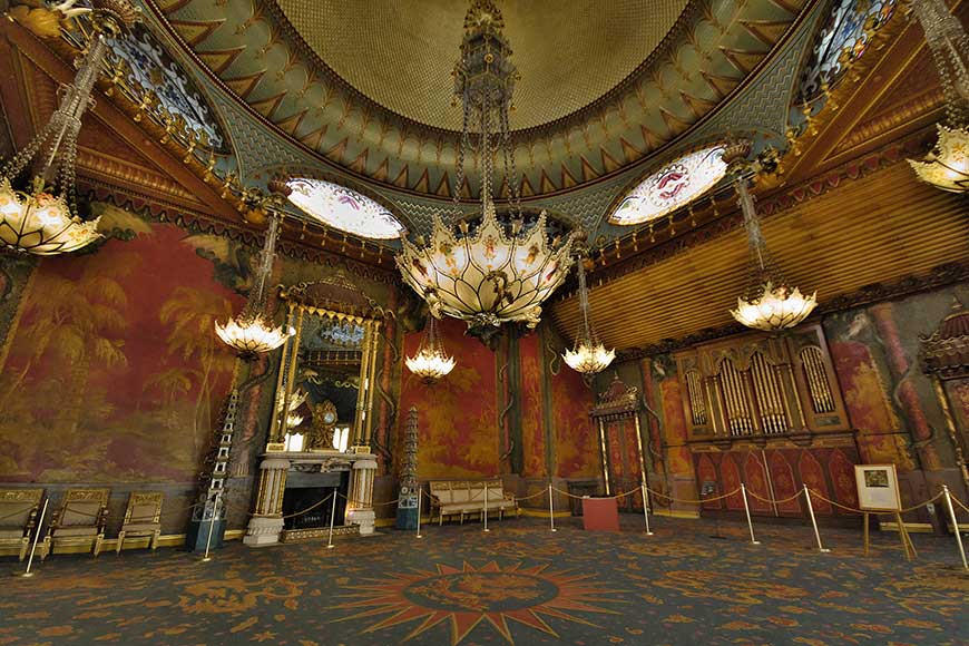 The Music Room at the Royal Pavilion in Brighton, with gilded mouldings, hand-painted Chinese wallpaper, and chandeliers inspired by lotus plants