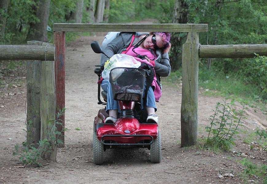 Electric Wheelchair user getting stuck under footpath barrier on country path