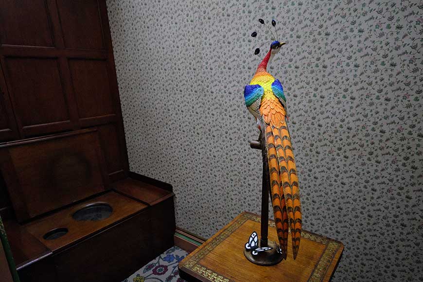 Multi coloured wood and paper bird sculpture in the Royal toilet at Brighton Royal Pavilion