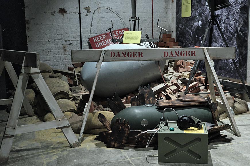 UXB exhibit at Newhaven Fort showing unexploded bomb danger signs and rubble