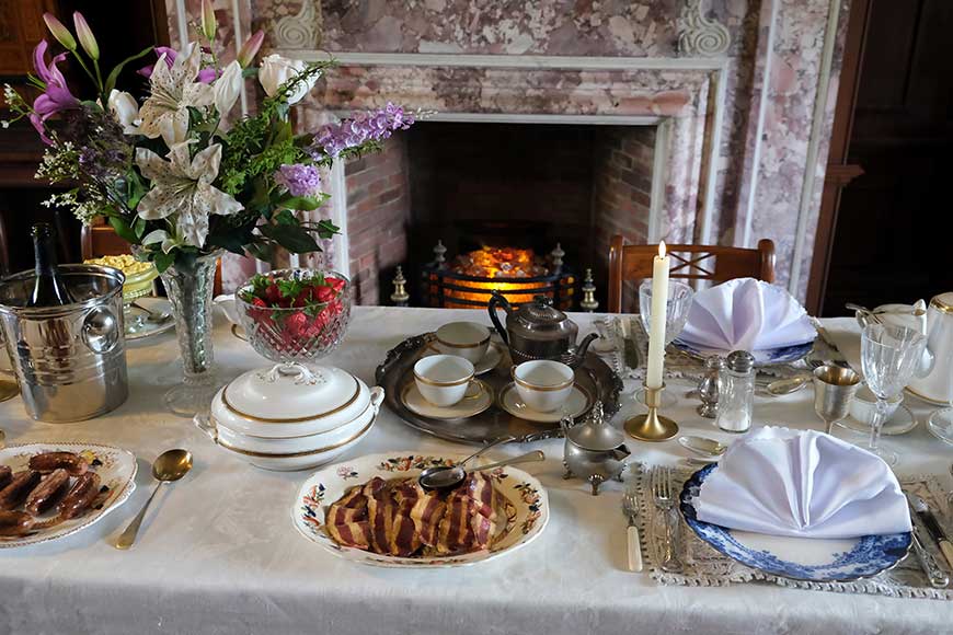 Table with imitation breakfast foods and flowers showing an Edwardian breakfast at Preston Manor, Brighton
