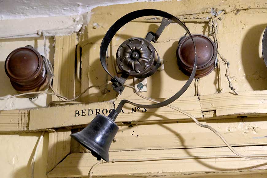 Room bell on the wall in the servants' corridor at Preston Manor in Brighton