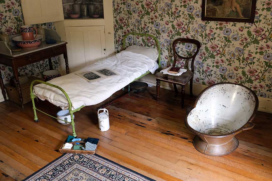 Maid's bedroom with single bed and metal bath tub. Preston manor Brighton