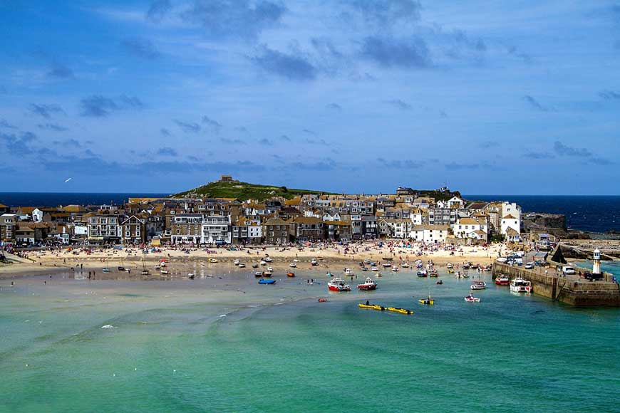 Aerial view of St Ives harbour in Cornwall on a sunny day.
UK seaside towns