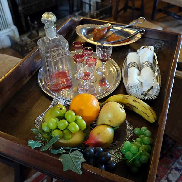 Edwardian supper tray with imitation fruit, decanter of drink, and chicken leg in the drawing room at Preston Manor, Brighton
