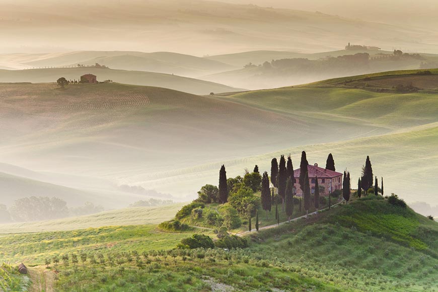 misty morning landscape in the Val d'Orcia region of Tuscany, Italy