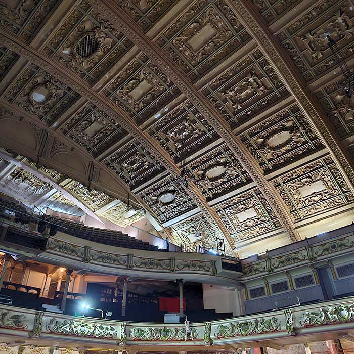 The historic and ornate fibrous plaster ceiling with a roof span of 118 feet and a height of 65 feet