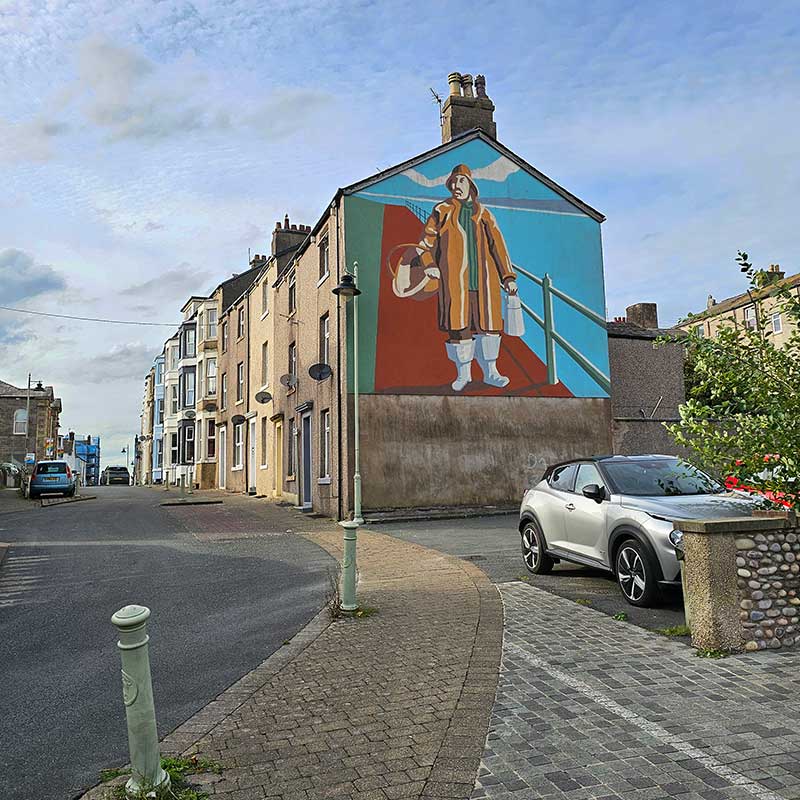 Mural of a Fisherman on the side of a house in Fisherman's Square Morecambe