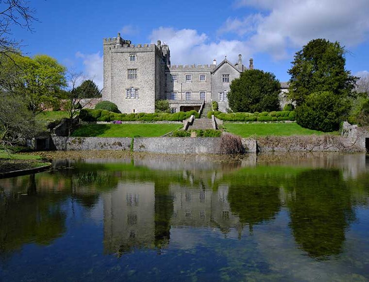 Castle reflected in the lake at Sizergh Castle, Cumbria