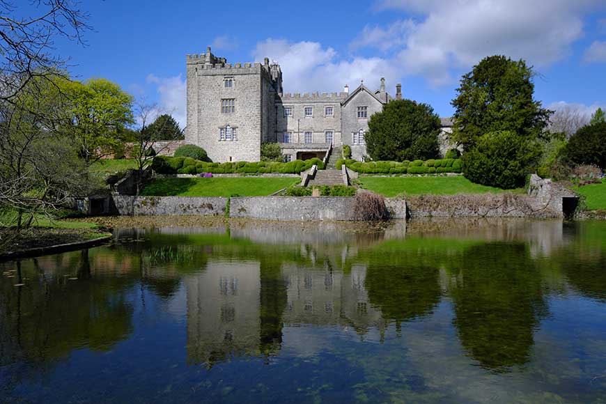 Castle reflected in the lake at Sizergh Castle, Cumbria